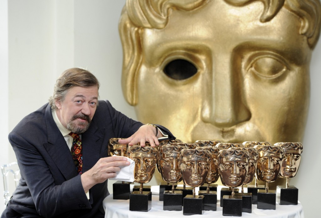 BAFTA Awards host Stephen Fry polishes the awards to be given at the upcoming ceremony, London. PRESS ASSOCIATION Photo. Picture date: Monday February 4, 2013. Photo credit should read: Jonathan Brady/PA Wire